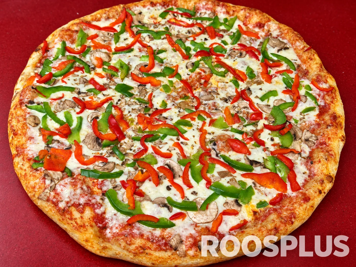 Cheese pizza topped with sliced red and green peppers and mushrooms at Bismillah Pizza, Eglinton Avenue East, Scarborough.