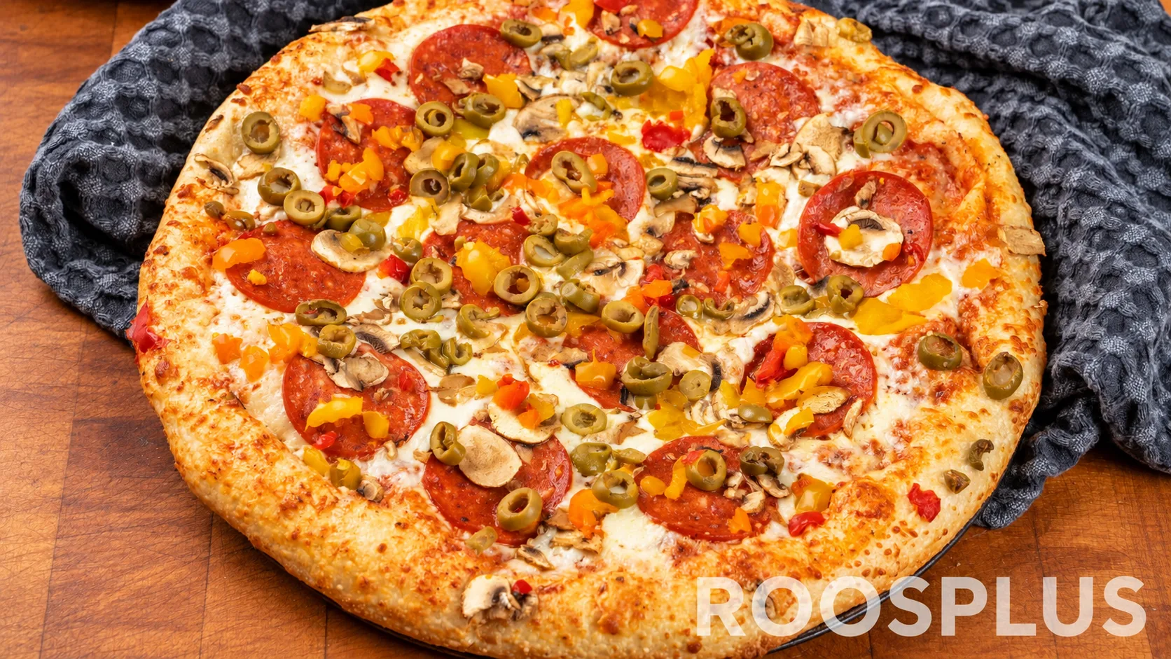 Cheese pizza topped with salami, mushrooms, green olives and diced peppers at Bismillah Pizza, Eglinton Avenue East, Scarborough.
