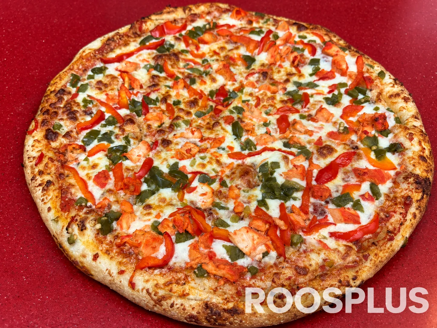 Pizza topped with tandoori chicken pieces and red and green peppers at Bismillah Pizza, Eglinton Avenue East, Scarborough.