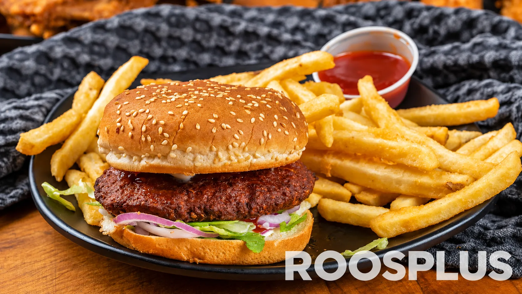 Sesame-seed burger with lettuce and red onion, served with French fries and dipping sauce at Bismillah Pizza, Eglinton Avenue East, Scarborough.