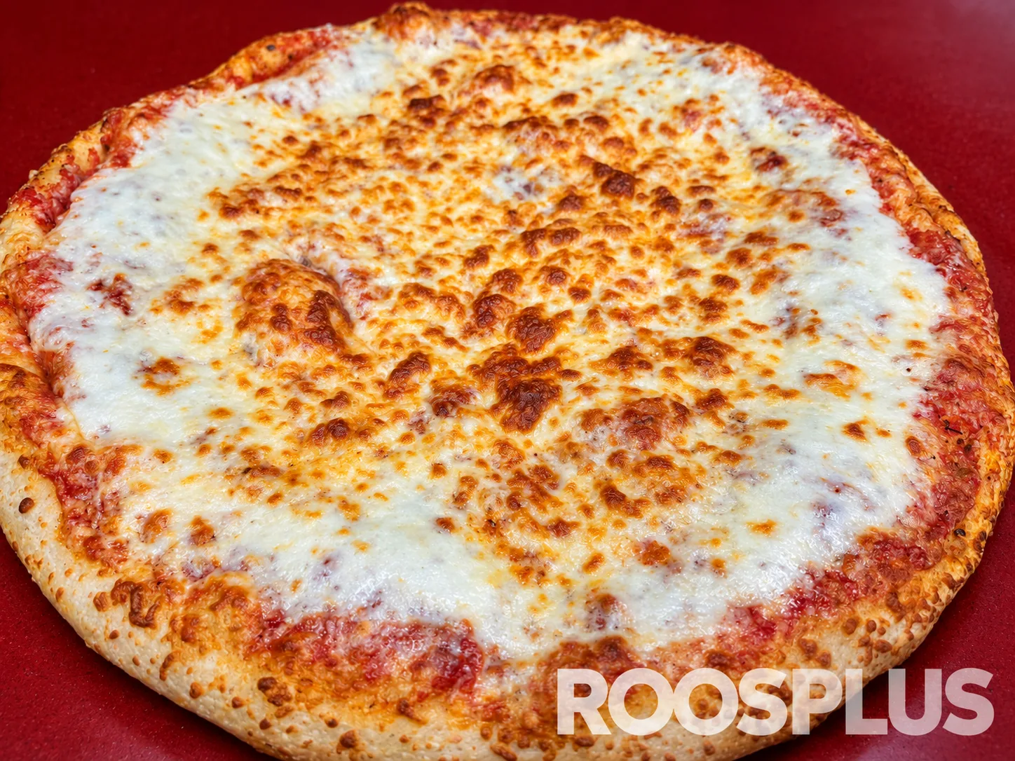 Close detail of melted mozzarella and browned cheese on a pizza at Bismillah Pizza, Eglinton Avenue East, Scarborough.