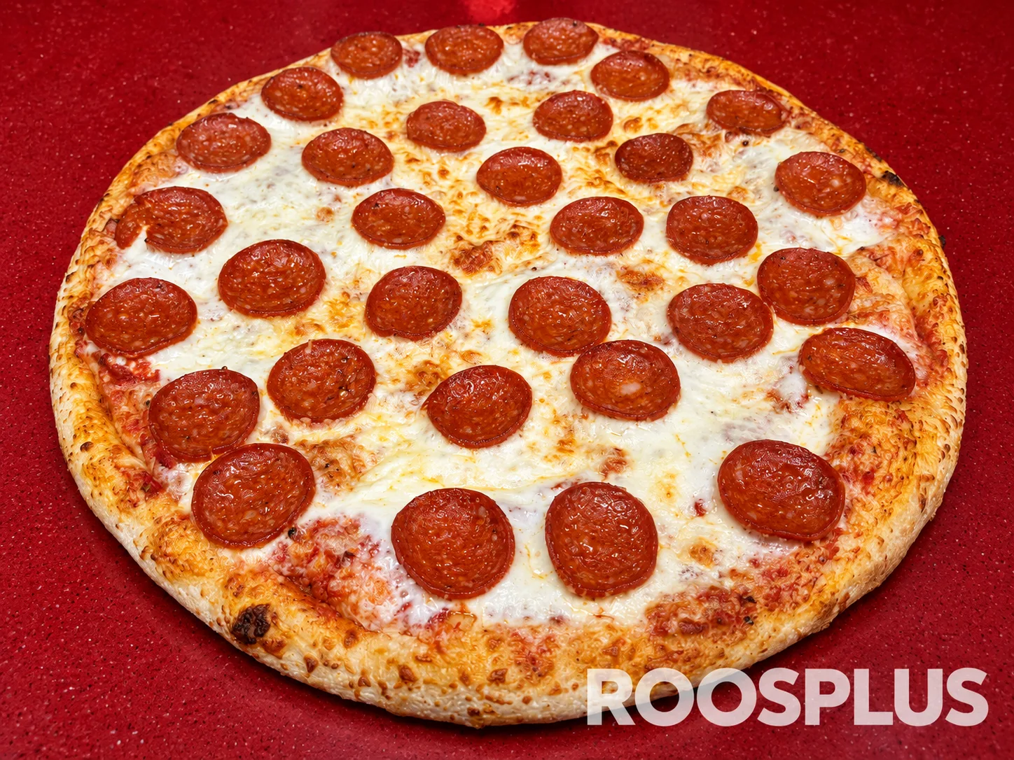 Full view of a cheese pizza topped with evenly spaced salami slices at Bismillah Pizza, Eglinton Avenue East, Scarborough.