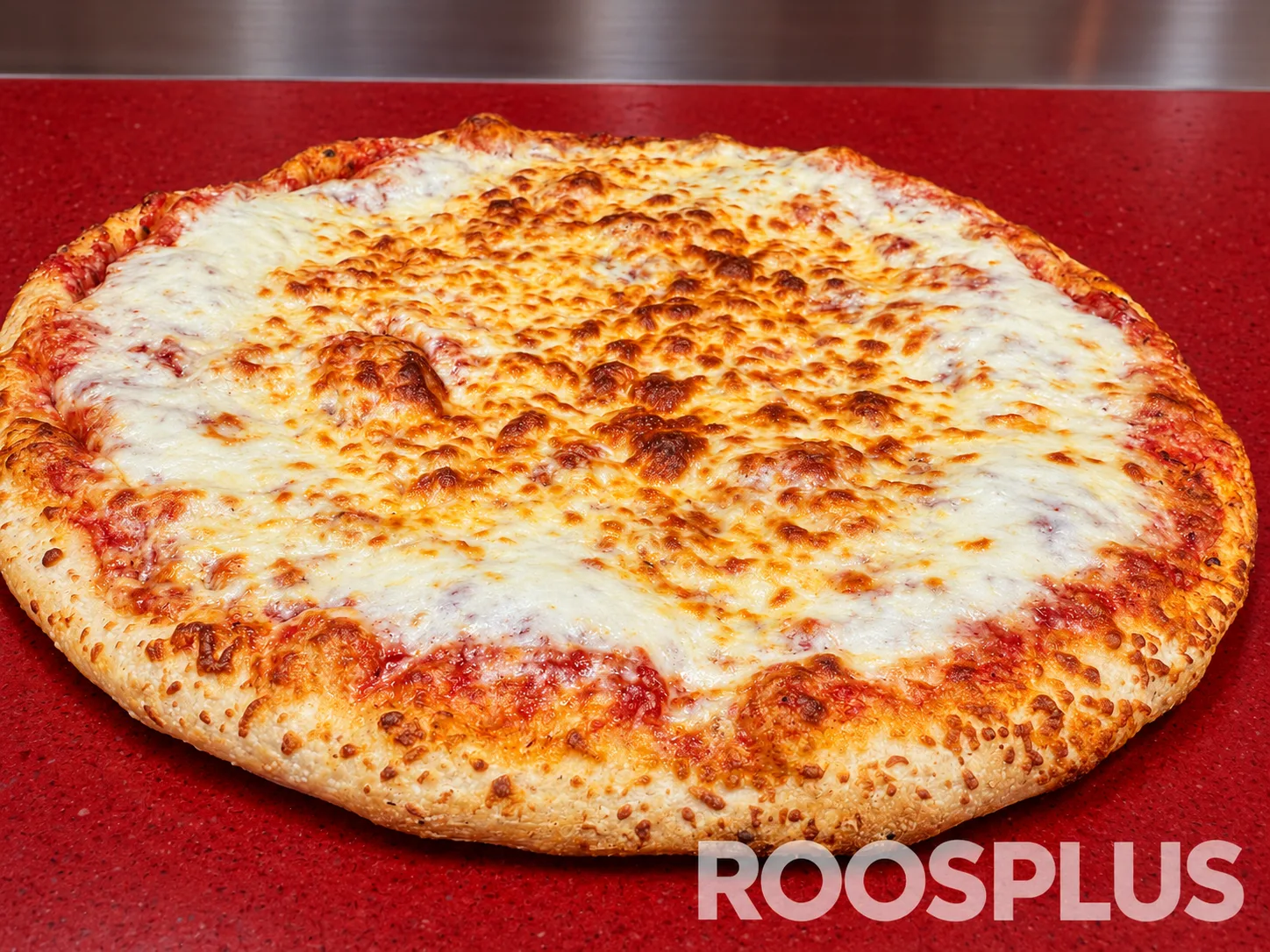 Low-angle view of a cheese pizza with browned mozzarella and golden crust at Bismillah Pizza, Eglinton Avenue East, Scarborough.