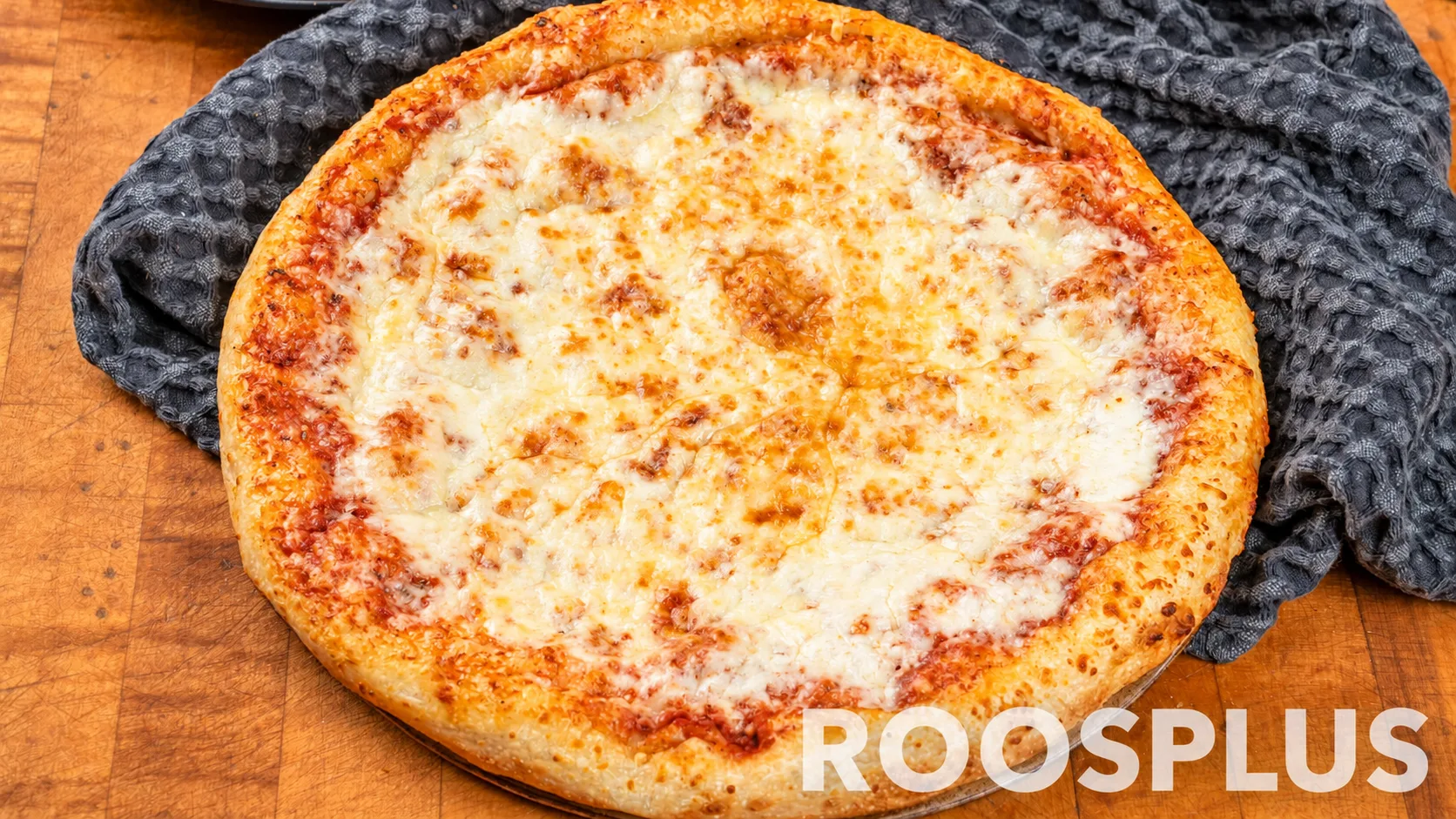 A classic cheese pizza with melted mozzarella and a golden crust at Bismillah Pizza, Eglinton Avenue East, Scarborough.