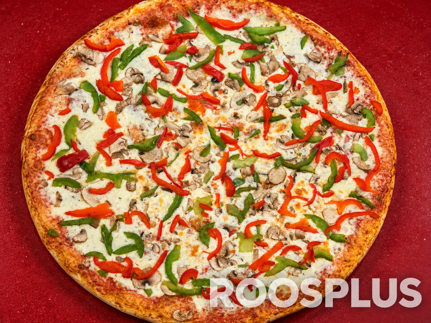 Overhead view of pizza topped with mushrooms and red and green peppers at Bismillah Pizza, Eglinton Avenue East, Scarborough.