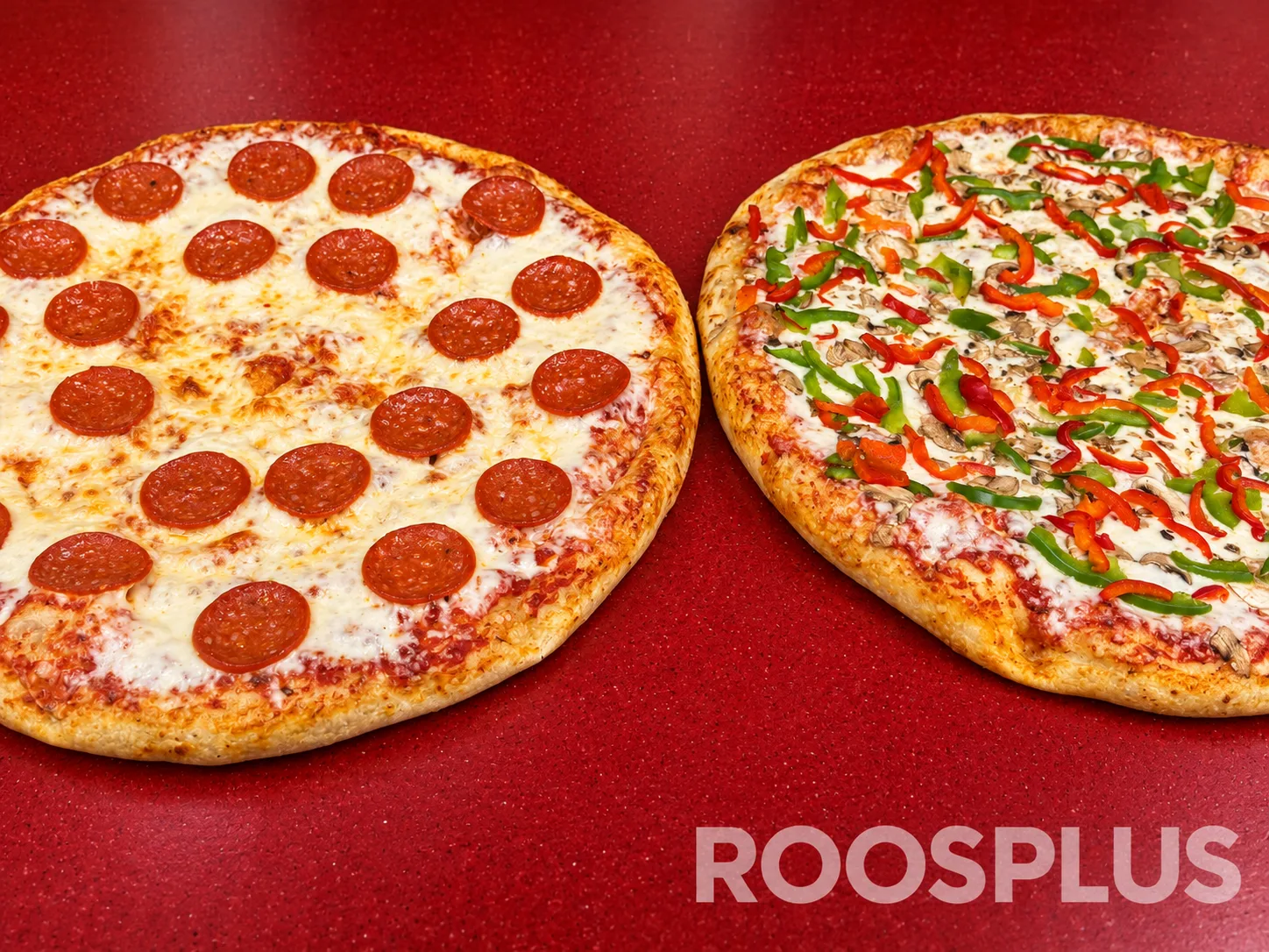 Two pizzas side by side: one topped with salami and one topped with mushrooms and peppers at Bismillah Pizza, Eglinton Avenue East, Scarborough.