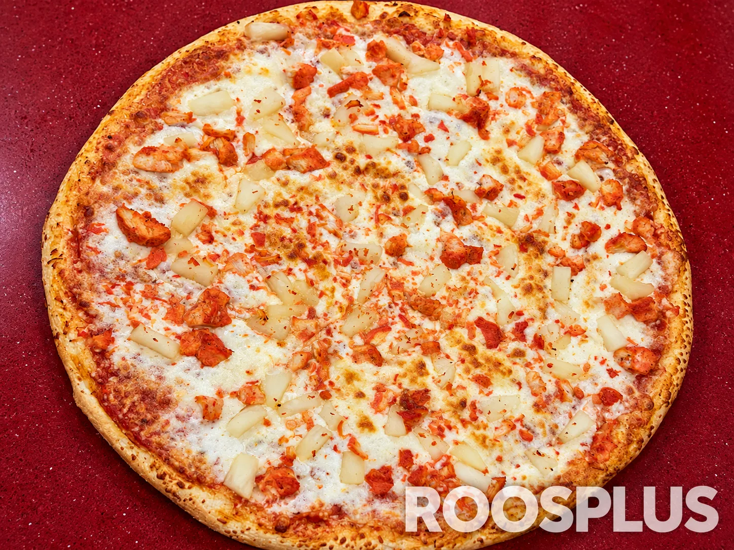 Cheese pizza topped with tandoori chicken pieces and pineapple chunks at Bismillah Pizza, Eglinton Avenue East, Scarborough.